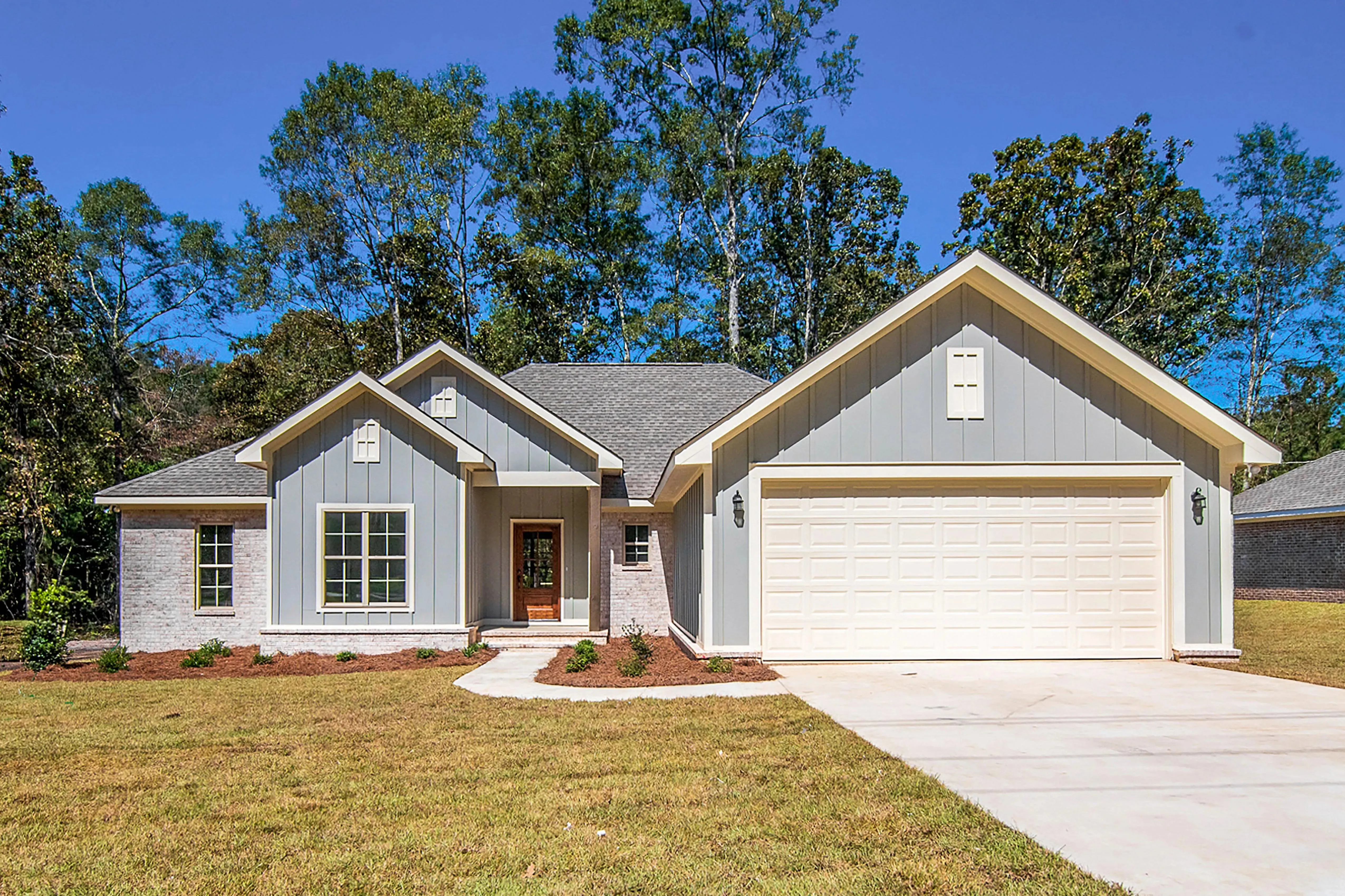 Charming 4-Bedroom Home Plan with Front Garage and Inviting Porch